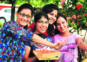 The students of the Khalsa College for Women in a jubilant mood after the declaration of BSc-II Biotechnology (Hons) results in Ludhiana. 