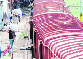 Porters load goods at the cargo facility in Amritsar on Wednesday