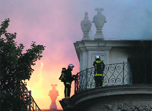 Firemen fight a blaze at the 17th-century Hotel Lambert on Wednesday in Paris.