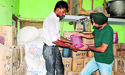 A health official (right) inspects samples in Amritsar on Wednesday