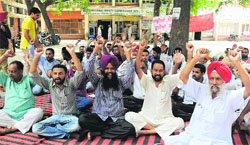 Contractual employees under the banner of the Punjab Subordinate Services Federation stage a protest outside the office of Zila Parishad in Bathinda on Thursday. Tribune photo: Pawan Sharma