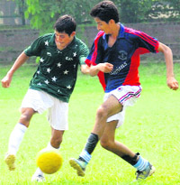 Players  in action at the Sector 17 football stadium in Chandigarh on Thursday. 