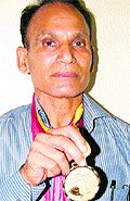 Chand Singh Yadav shows his medal