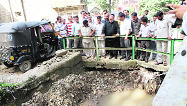 Health Minister Kaul Singh Thakur inspects a flooded nullah near the Zonal Hospital in Mandi on Thursday.