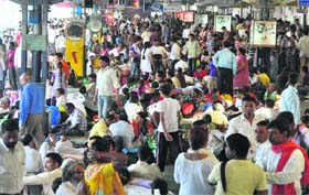 More of us: Passengers at the railway station mirror the strength of numbers the country has achieved on the World Population Day in Jammu on Thursday