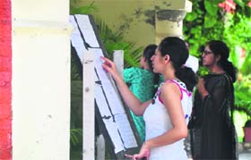 Students go through the lists displayed at Khalsa College for Women in Ludhiana on Thursday