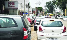 Vehicles parked haphazardly on a road near a hospital in Model Town, Ludhiana