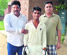 Budding cricketer Nipun Dogra (centre)