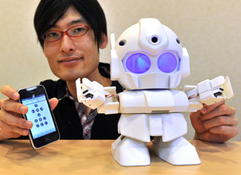 Japanese engineer Shota Ishiwatari displays the humanoid robot Rapiro which works with a Raspberry Pi, in Tokyo.