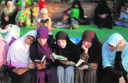 Supporters of the Muslim Brotherhood read the Koran outside Cairo's Rabaa al-Adawiya mosque on Wednesday.  AFP
