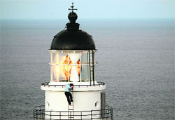 A government employee inspects a lighthouse at Santiaochiao in New Taipei City as super-typhoon Soulik approaches northern Taiwan on Thursday. Taiwan evacuated over 2,000 tourists as the island braced for the Soulik.  AFP