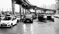 Vehicles negotiate a waterlogged road after a downpour in Gurgaon on Friday