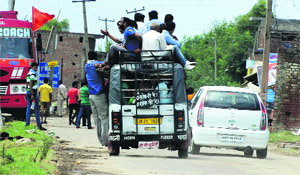 An overloaded mini bus on the outskirts of Jammu on Friday. 