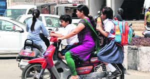 A woman takes her children back home after their van did not turn up to pick them up on Friday afternoon. 