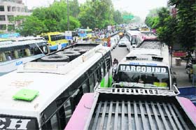 Bumper to bumper: Private buses parked outside the bus stand create traffic bottlenecks in Bathinda on Saturday