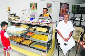 Vivek, along with his father Jai Shiv Sharma, at the Pandit Jethu Ram Mishtan Bhandar. The shop will turn 100 next year