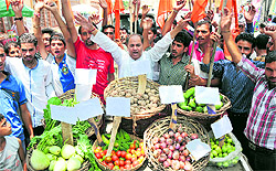 Activists of the Dogra Front protest against the increasing price of vegetables in Jammu on Saturday