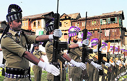 Policemen perform a drill at the martyrs graveyard in Srinagar on Saturday