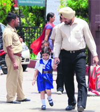 With school van operators having gone on strike, a parent picks up his daughter from a school in Ludhiana.
