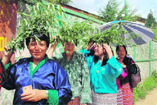 Women wait in a queue to vote at a polling station in Thimphu on Saturday.