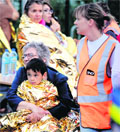 Rescuers help people at the site of a train accident at the Bretigny-sur-Orge railway station near Paris on Friday. 