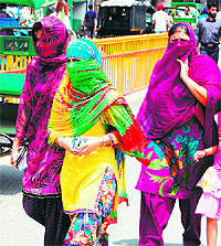 Girls cover their faces on a hot summer day in Amritsar on Sunday