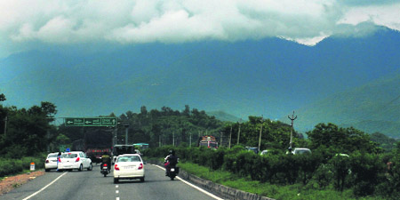 A pleasant view of clouds and hills witnessed from the Panchkula-Kalka highway.