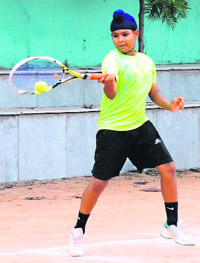 A player in action during a match of the Mount Carmel Total Tennis Championship at the Total Tennis Academy, Mount Carmel School, Chandigarh, on Sunday.