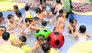 Children have fun during a splash pool party at CRB Public School, Sector 7B, Chandigarh.