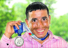 Sukhwinder Singh flaunts the medal which he won in the South Korean Winter Games in January this year. 