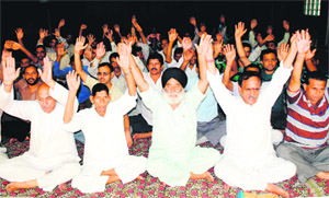 Members of the National Mazdoor Conference (NMC) stage a protest in support of their pending demands in Jammu on Sunday. 