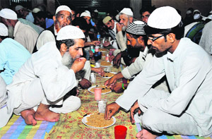 Muslims break fast at the Jamia Masjid, Talab Khatinkan, in Jammu on Sunday. Muslims all over the world are observing fast during the holy month of Ramadan.