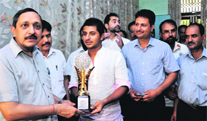 Director General, Department of Youth Services and Sports, Naveen Aggarwal, felicitates cricketer Shubam Khajuria in Jammu on Sunday.