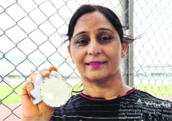 Jatinder Kaur shows the silver medal she won in the hammer throw event at the National Masters Athletics Championship.