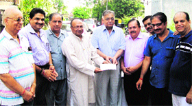 Members of various organisations at a function to collect donations for the flood-hit.