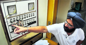 Gurmeet Singh, an employee of the BSNL, shows a telegram machine in Ludhiana.