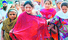 Grieving wife of linesman Sarabjit Singh in Tarn Tarans Kazikot village on Saturday
