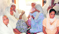 Family members of Balwinder Singh mourn his death at his residence in Amritsar on Monday. 