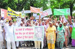 Family members of Sepoy Jugraj Singh (inset) of Jeeda village and Naik Bir Singh of Khiyala village along with the residents hold a demonstration outside the District Administrative Complex in Bathinda on Monday