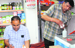 Officials of the Food and Supplies Department collect samples from a shop in Panchkula on Monday. A Tribune photograph