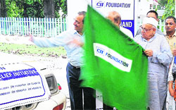 Uttarakhand Governor Aziz Qureshi flags off relief material sent by the CII for disaster-affected people in Dehradun on Monday. Tribune photograph