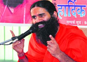 Yoga guru Ramdev addresses a convention in Hamirpur on Monday