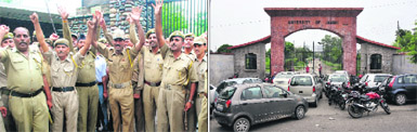Jammu University security personnel protest outside the main gate of the varsity in Jammu on Monday; (right) vehicles parked outside the gate as it is locked in protest.