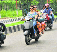 Girls riding two-wheelers without helmets is a common sight.