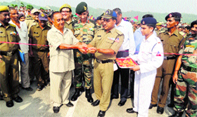 The sarpanch of Battal village cuts the ribbon at the inauguration of the Battal Bridge on Monday.