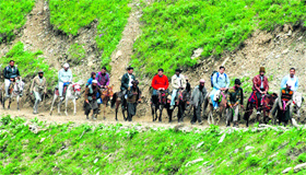 Pilgrims cross Baltal in Sonamarg while on their way to the Amarnath cave shrine on Monday.