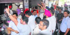 Protesting against the new policy of the state government on illegal colonies, colonisers force down shutters of offices of deed writers at tehsil complex in Jalandhar.