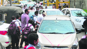 Long queues of vehicles are seen outside DAV Public School, BRS Nagar, as vans and school buses remain off road.