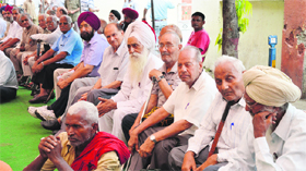 Members of the All-India Railway Retired Mens Federation protest outside the Railway Hospital in Ludhiana on Monday.