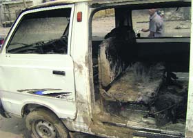A partially burnt Maruti van in Sangrur on Monday